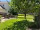 Serene backyard featuring a lush green lawn, framed by mature trees and a charming wooden fence at 22991 Hope Dale Ave, Parker, CO 80138