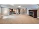 Finished basement featuring a fireplace, carpet floors, wet bar and neutral paint at 22991 Hope Dale Ave, Parker, CO 80138