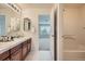 Bright bathroom with a double vanity, tile flooring, and a separate tub/shower area at 22991 Hope Dale Ave, Parker, CO 80138