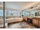 Bright bathroom with a soaking tub, double vanity, and large windows at 22991 Hope Dale Ave, Parker, CO 80138