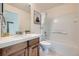 Well-lit bathroom featuring a combination tub and shower, vanity with a sink, and neutral decor at 22991 Hope Dale Ave, Parker, CO 80138