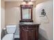 Powder room with decorative wood vanity and granite countertop and updated fixtures at 22991 Hope Dale Ave, Parker, CO 80138