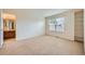 Bright, carpeted bedroom with a window and built-in shelving, offering versatile space at 22991 Hope Dale Ave, Parker, CO 80138