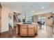 Open-concept kitchen with center island, stainless appliances, and hardwood flooring at 22991 Hope Dale Ave, Parker, CO 80138
