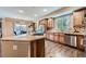 Modern kitchen with stainless steel appliances, granite countertops, and hardwood floors at 22991 Hope Dale Ave, Parker, CO 80138