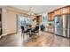 Eat-in kitchen featuring stainless steel appliances, custom cabinetry, and hardwood flooring at 22991 Hope Dale Ave, Parker, CO 80138