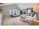 Spacious main bedroom featuring a cozy fireplace, large windows, and ample natural light at 22991 Hope Dale Ave, Parker, CO 80138