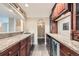 Basement wet bar with granite countertops, sink, and cabinetry with a beverage refrigerator at 22991 Hope Dale Ave, Parker, CO 80138