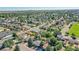 Aerial view showcasing the home's setting in a residential neighborhood near a park at 5183 Durham Ct, Denver, CO 80239