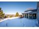 Spacious backyard with a deck, trees, and distant city views at 11143 W Ohio Pl, Lakewood, CO 80226