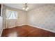 Bedroom with hardwood floors, floral wallpaper, and a chandelier at 11143 W Ohio Pl, Lakewood, CO 80226