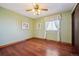 Bedroom with hardwood floors, light green walls, and a ceiling fan at 11143 W Ohio Pl, Lakewood, CO 80226