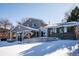 Back exterior view of house with deck and snowy yard at 11143 W Ohio Pl, Lakewood, CO 80226