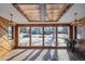 Sunroom with large windows, wood paneling, and tile flooring, providing abundant natural light at 11143 W Ohio Pl, Lakewood, CO 80226