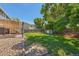Backyard features a spacious lawn, a shed, a shaded patio, and a fenced perimeter for privacy at 3965 S Fundy Cir, Aurora, CO 80013