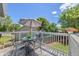 Outdoor dining setup on a deck with a large umbrella, surrounded by lush greenery and sunny skies at 3965 S Fundy Cir, Aurora, CO 80013