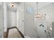 Bright foyer with a decorative light fixture and dark hardwood floors, leading into the home at 3965 S Fundy Cir, Aurora, CO 80013