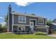 A gray two-story home with an attached garage and landscaped front yard at 3965 S Fundy Cir, Aurora, CO 80013