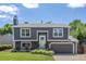 Charming two-story home with a well-maintained lawn, landscaped flower beds, and a gray exterior paint at 3965 S Fundy Cir, Aurora, CO 80013