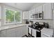 Bright kitchen featuring white cabinets, stainless appliances and granite countertop at 3965 S Fundy Cir, Aurora, CO 80013