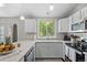 Kitchen features white cabinets, stainless appliances and granite countertop at 3965 S Fundy Cir, Aurora, CO 80013