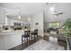 Bright kitchen featuring white cabinets, stainless appliances, and a breakfast bar that opens to the living area at 3965 S Fundy Cir, Aurora, CO 80013
