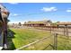 Large, fenced backyard with green lawn, perfect for outdoor activities and relaxation at 5960 Glencoe St, Commerce City, CO 80022