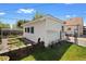 The backyard features a greenhouse and a shed with a manicured lawn at 5960 Glencoe St, Commerce City, CO 80022