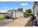 Backyard features a storage shed, trailer parking, landscaping and additional work or storage space at 5960 Glencoe St, Commerce City, CO 80022