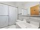 Bright bathroom featuring a vanity, toilet, mirror, and shower with sliding glass doors at 5960 Glencoe St, Commerce City, CO 80022