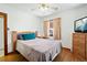 Traditional bedroom with hardwood floors, ceiling fan, and a large window at 5960 Glencoe St, Commerce City, CO 80022