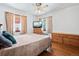 Relaxing bedroom with hardwood floors, natural light, and ceiling fan at 5960 Glencoe St, Commerce City, CO 80022