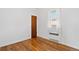 Simple bedroom with hardwood floors, door and a window providing lots of natural light at 5960 Glencoe St, Commerce City, CO 80022