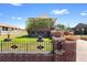 Charming brick home featuring a landscaped yard and unique architectural details on a sunny day at 5960 Glencoe St, Commerce City, CO 80022