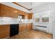 Traditional kitchen with wood cabinets, under-cabinet lighting, and vinyl floors at 5960 Glencoe St, Commerce City, CO 80022