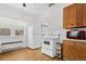 Cozy kitchen with white appliances, lots of light, and wooden cabinets at 5960 Glencoe St, Commerce City, CO 80022