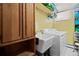 Functional laundry room with a sink, washer, dryer, and ample cabinet space for storage and organization at 5960 Glencoe St, Commerce City, CO 80022