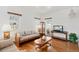 Bright living room with hardwood floors, large windows, and classic furnishings at 5960 Glencoe St, Commerce City, CO 80022