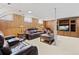 Basement living room features comfortable seating, warm lighting, and built-in entertainment center at 5960 Glencoe St, Commerce City, CO 80022