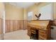 Traditional office with wooden paneling, rolltop desk, and natural light at 5960 Glencoe St, Commerce City, CO 80022