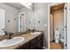 Bathroom boasts double sinks, granite countertop and shower at 8939 Devinney Ct, Arvada, CO 80005