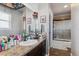 Bathroom with a shower/tub combo and vanity with lots of storage at 8939 Devinney Ct, Arvada, CO 80005