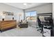 Bright bedroom with large window, comfy chair, and built-in workspace at 8939 Devinney Ct, Arvada, CO 80005