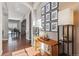 Elegant entryway with hardwood floors, decorative console table, and framed artwork at 8939 Devinney Ct, Arvada, CO 80005