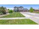 Two-story house with a landscaped yard, driveway, and attached garage at 8939 Devinney Ct, Arvada, CO 80005