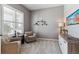 Cozy home office featuring comfortable seating, built-in shelving and large window with plantation shutters at 8939 Devinney Ct, Arvada, CO 80005