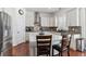 Modern kitchen with white cabinets, stainless steel appliances, and large island with seating at 8939 Devinney Ct, Arvada, CO 80005