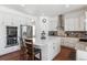 Spacious kitchen with stainless steel appliances and an island at 8939 Devinney Ct, Arvada, CO 80005