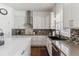 Modern kitchen featuring white cabinets and a sleek sink at 8939 Devinney Ct, Arvada, CO 80005