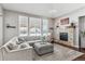 Open concept living room with a sectional sofa and large windows at 8939 Devinney Ct, Arvada, CO 80005